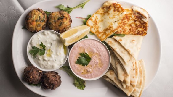 The mezze plate for two includes garlicky tzatziki and salmon-pink taramasalata.