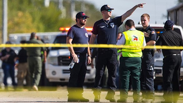 Law enforcement officials at the scene of a fatal shooting at the First Baptist Church in Sutherland Springs, Texas, on Sunday.