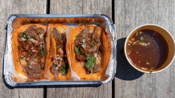 Birria tacos served with a consomme soup for dipping.