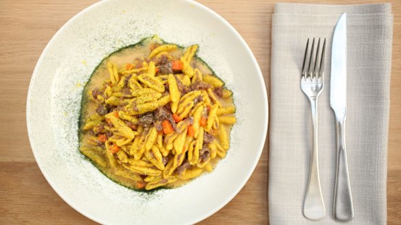 Saffron capunti pasta with ossobuco ragu and gremolata.