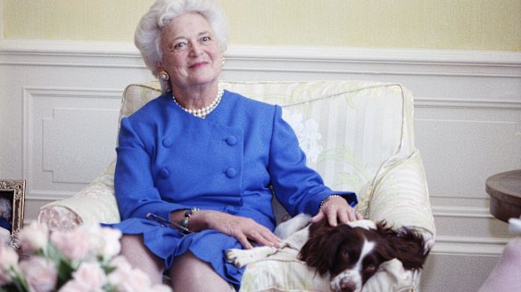 Barbara Bush poses with her dog Millie in Washington, 1990.
