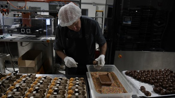 Zokoko's chief chocolatier Andre Sandison puts the final touches on assorted milk, dark and white chocolate eggs.