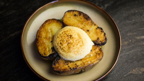 Royal blue potatoes topped with a cloud of mustard foam.