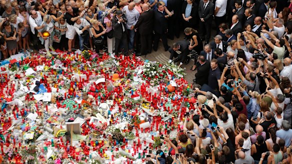 Spanish King Felipe, Queen Letizia lay flowers at a memorial tribute of flowers, messages and candles to the van attack victims in Las Ramblas.
