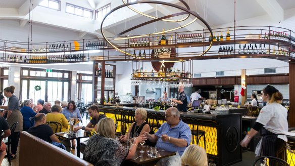 Gourmet Paddock's interior features an elevated wine rack stocked with local drops.
