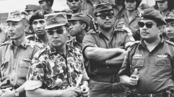 Former Indonesia president Suharto (in patterned uniform) was a major-general in 1965. Here he attends the funeral of the slain generals. He had a leading role in the anti-communist crackdown and massacres that followed.
