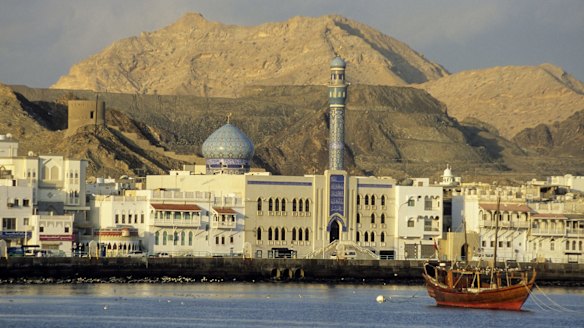 An Arab dhow, Shia mosque and traditional waterfront architecture in Muscat, Oman.