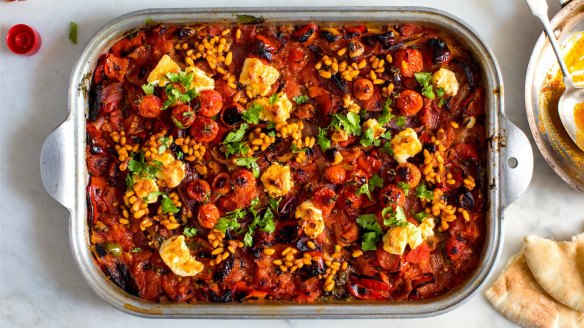 Charred tomatoes with feta and harissa pine nuts, a dish inspired by North African salads.