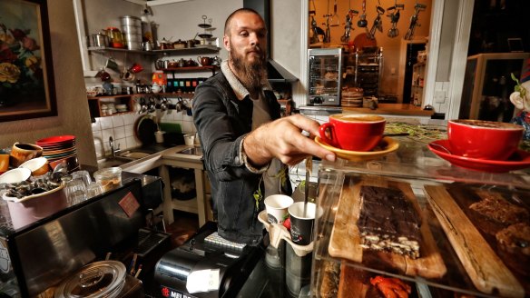 Melbourne Demons footballer Max Gawn in his family's cafe in Loch, Gippsland. His mother's hedgehog slice (bottom right) will feature on his food truck menu.