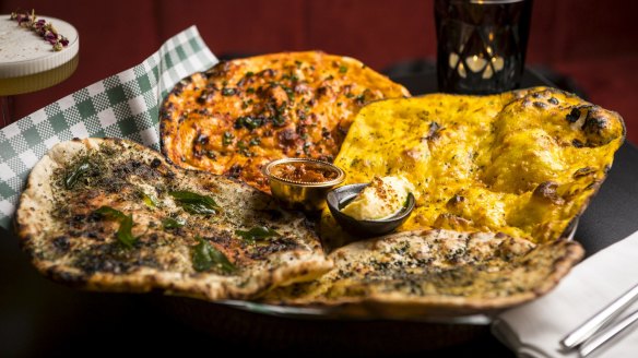 Assorted flatbreads including pratha with comte cheese.