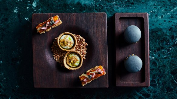 Opening snacks at Navi might include black garlic macarons (right).