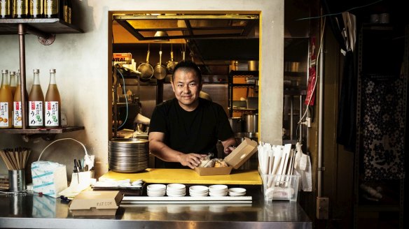 Chef and owner Keita Abe of Chaco Ramen prepares takeaway food.