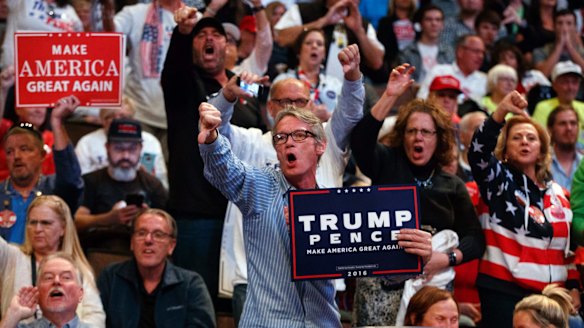 Supporters of Republican presidential candidate Donald Trump yell at reporters as they arrive at a rally in Cincinnati, Ohio, on Thursday.