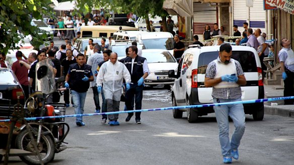 Police forensic experts examine the street following an attack on police officers in Diyarbakir, Turkey, on Thursday.