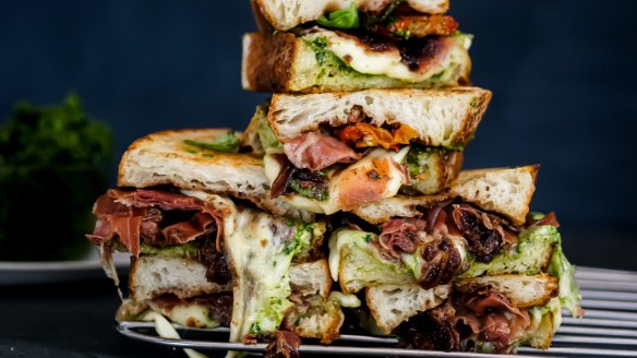 Loaded caprese toasted sandwich with pesto and onion jam.