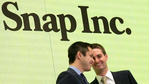 Snapchat co-founders Bobby Murphy, left, and CEO Evan Spiegel ring the opening bell at the New York Stock Exchange as the company celebrates its IPO.