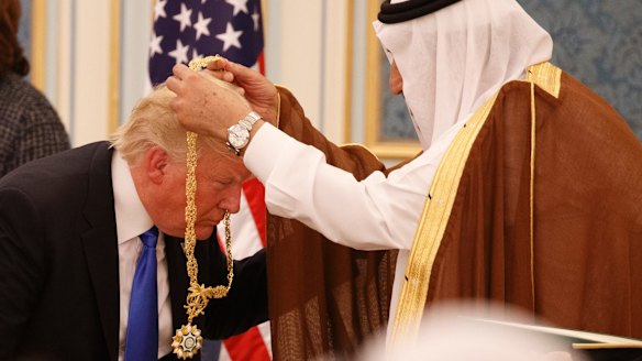 Saudi King Salman presents President Donald Trump with the Collar of Abdulaziz Medal in  Riyadh.