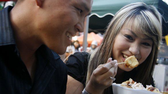 Visitors enjoying Chinatown street food.