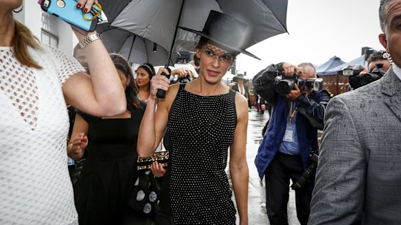 Hilary Swank dodging a shower at Derby Day.