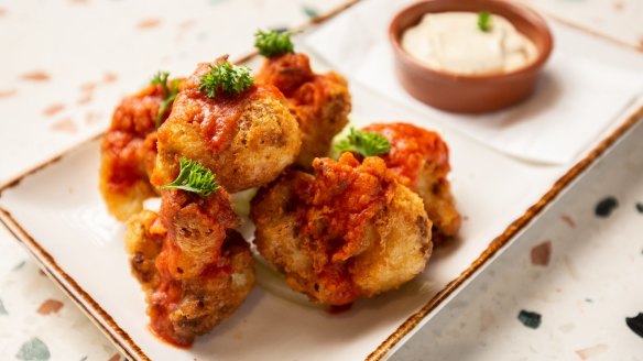 Cauliflower 'wings' with vegan ranch dipping sauce.