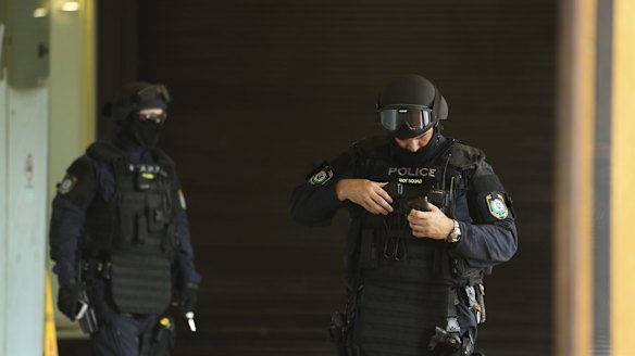 Riot police carry out raids at two western Sydney addresses