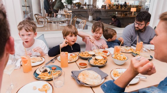 Children enjoy a Greek food fix (and chips!) at Topikos in Bondi Beach.