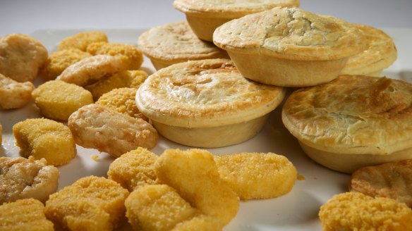 A selection of brands of frozen meat pies and chicken nuggets which have been cooked.