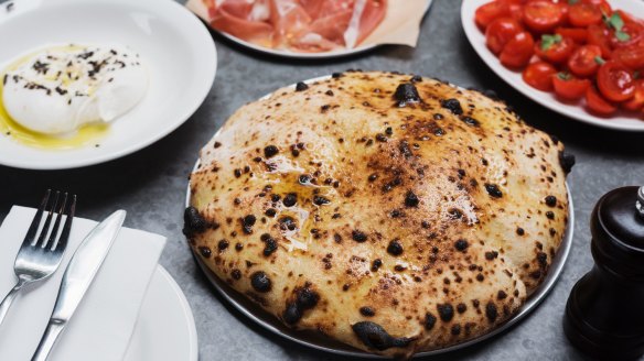 Wood-fired bread from Totti's with prosciutto, burrata and tomato antipasti.