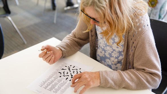 Maree, like many regulars at Uniting's early morning centre, enjoys solving a crossword with breakfast.