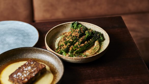 Charred sprouting broccoli on a bed of pale, creamy anchoiade showered with pangrattato.