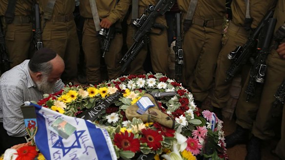 Israeli soldiers at the grave of Hadar Goldin during his funeral in Kfar Saba on August 3.