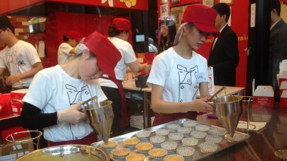Employees working on pastries at Uncle Tetsu's Japanese Cheesecake store at Regent Place.