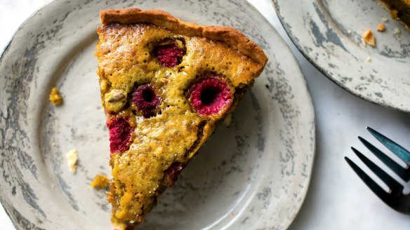 A slice of pistachio and raspberry tart.