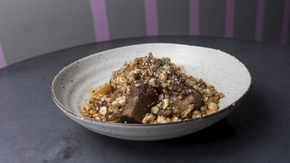 Tagine of lamb shoulder with prune, hazelnut and maftoul.