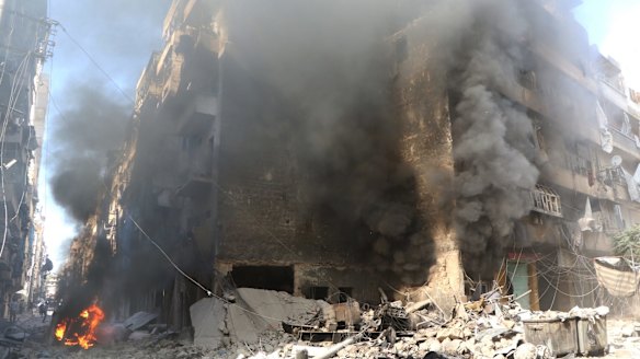 Smoke rises from an Aleppo building after an air strike in September.