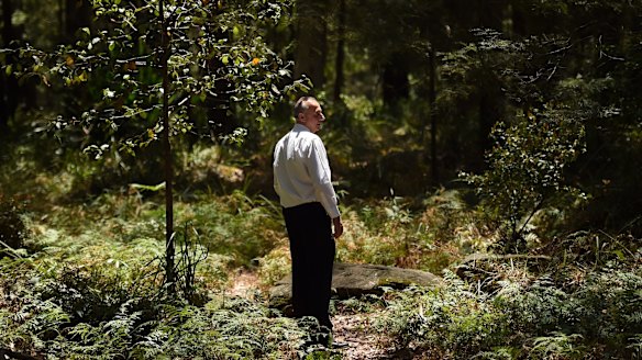 A detective from the Homicide Squad stands at a crime scene in the Royal National Park.