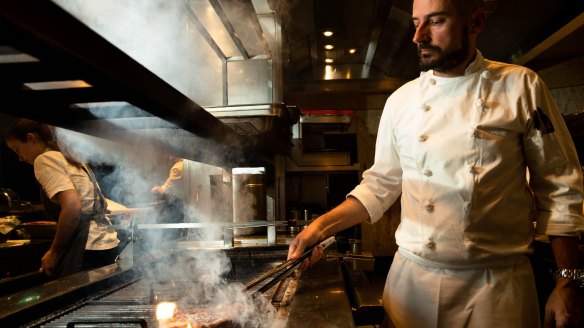 Corey Costelloe grills a rib-eye at Rockpool Bar & Grill. The culinary director says as more chefs shift to secondary steak cuts, they push the price up higher and higher.