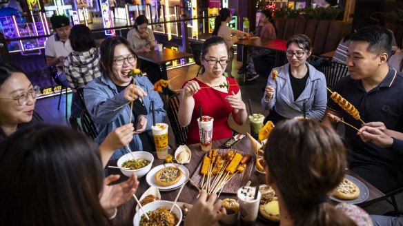 Friends gather at Burwood Chinatown to experience novel dishes such as dango mochi sticks and hotteok, a filled pancake.