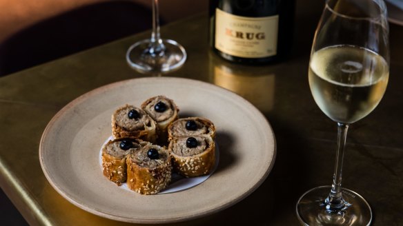 Krug champagne paired with suckling pig sausage rolls at Bennelong in Sydney.