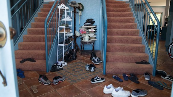 Shoes in the foyer of one of many properties rented by Frank Lin and turned into boarding houses for Taiwanese nationals who are working at the nearby Thomas Foods plant. 