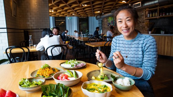 Chat Thai owner Palisa Anderson with one of the restaurant's spiciest dishes, a yellow crab curry.