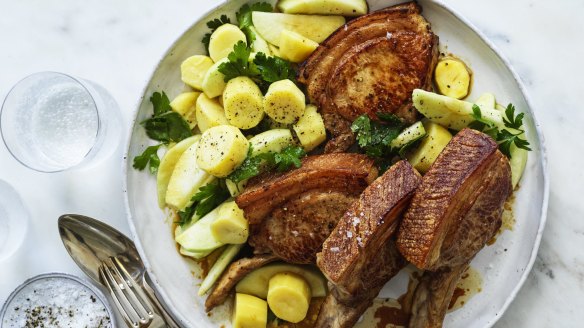 Pork chops with apple and potato salad.
