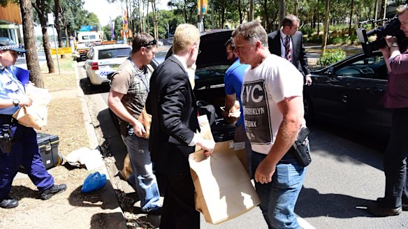 Police take evidence from an upmarket apartment at Sydney's Olympic Park on Tuesday.