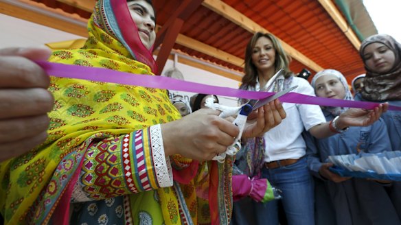 Malala Yousafzai cuts a ribbon near Noura Jumblatt (centre), founder of the Kayany Foundation, at the foundation's school for Syrian refugee girls.