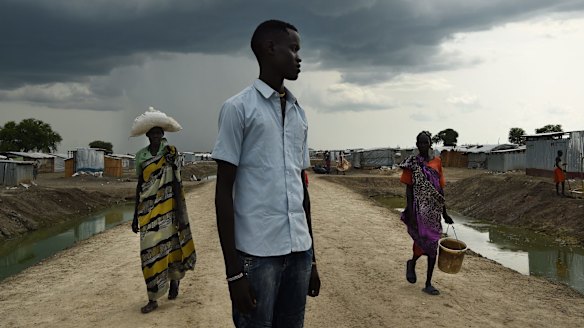 John Bol Khat (centre), 25, lives inside the UN Bentiu Protection of Civilians (POC) site that is guarded against soldiers and militia.  