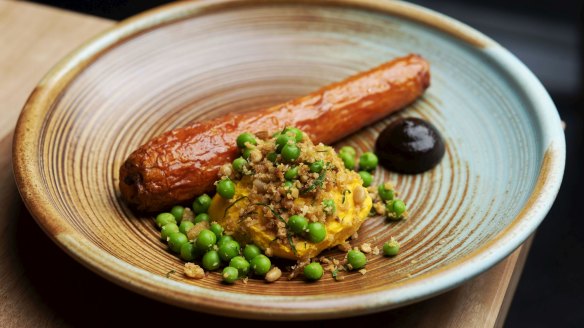 Roast carrot with black garlic, carrot puree, sourdough, pinenuts and peas.