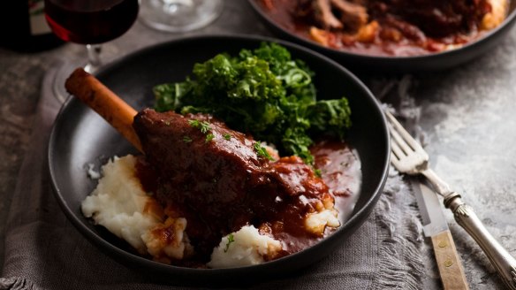 Lamb shanks cooked in red wine sauce and served with mashed potato and kale.