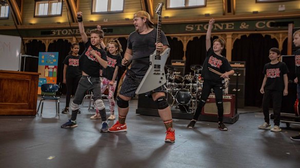 Brent Hill with younger cast members during rehearsals for School of Rock in Melbourne.