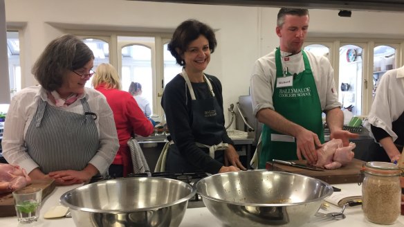 Julie Gibbs (centre) during a chicken class at the cooking school.