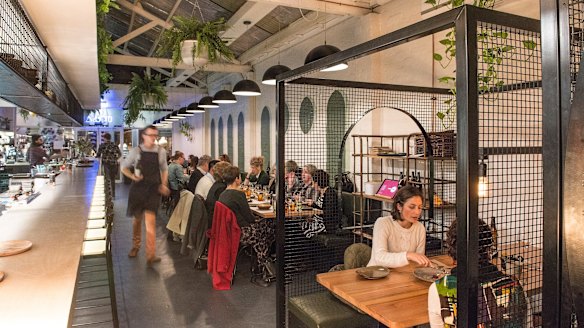 Cage-like booths inside Holla Food & Drink.